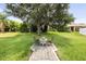 Wide backyard features a paved sitting area with two chairs and well-kept lawn at 3856 Shoreside Dr, Kissimmee, FL 34746