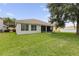 Wide backyard shows the back of the home with a screen patio and well-kept lawn at 3856 Shoreside Dr, Kissimmee, FL 34746
