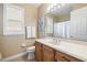 Well-lit bathroom featuring a vanity, window, and shower with a bathtub at 3856 Shoreside Dr, Kissimmee, FL 34746