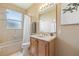 Bright bathroom features a combination shower and tub with tile walls and a wood vanity at 3856 Shoreside Dr, Kissimmee, FL 34746