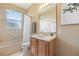 Bright bathroom features a shower and tub combination, a vanity with storage, and a large mirror at 3856 Shoreside Dr, Kissimmee, FL 34746