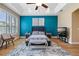 Stylish bedroom featuring a tray ceiling, contemporary art, and a mounted flat screen television at 3856 Shoreside Dr, Kissimmee, FL 34746