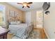 Comfortable bedroom showcasing a cozy bed, warm lighting, and access to an ensuite bathroom at 3856 Shoreside Dr, Kissimmee, FL 34746