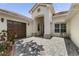 Charming, light-colored home featuring a well-manicured front yard, brown garage door and a cozy table and chairs on the side at 3856 Shoreside Dr, Kissimmee, FL 34746