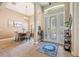 Elegant foyer showcasing a dining table, chandelier, tile flooring and a front door with decorative glass at 3856 Shoreside Dr, Kissimmee, FL 34746