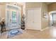 Foyer showcasing a front door with decorative glass, storage closet, neutral paint colors, and easy access to other areas of the home at 3856 Shoreside Dr, Kissimmee, FL 34746