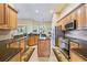Well-equipped kitchen features wood cabinetry, granite countertops, stainless steel appliances and a functional center island at 3856 Shoreside Dr, Kissimmee, FL 34746