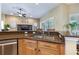 Open kitchen with granite counters, stainless appliances, breakfast bar, and seamless flow to the living area at 3856 Shoreside Dr, Kissimmee, FL 34746