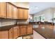 Spacious kitchen boasts wood cabinets, granite countertops, stainless steel appliances, and ample counter space at 3856 Shoreside Dr, Kissimmee, FL 34746