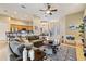 Spacious living room with a large sofa, decorative rug, and an open floor plan with views into the kitchen and dining areas at 3856 Shoreside Dr, Kissimmee, FL 34746