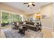 Comfortable living area featuring a large sectional sofa, sliding glass doors to the outside patio, and open access to the kitchen at 3856 Shoreside Dr, Kissimmee, FL 34746