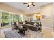 Comfortable living room with a large sectional sofa, decorative rug, and sliding glass doors to the outside at 3856 Shoreside Dr, Kissimmee, FL 34746