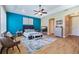 Bright main bedroom featuring a ceiling fan, gray toned furniture and an en-suite bathroom at 3856 Shoreside Dr, Kissimmee, FL 34746