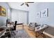 Well-lit office with gray walls, wood floors, desk, rolling chair, two accent chairs, and closet at 3856 Shoreside Dr, Kissimmee, FL 34746