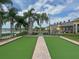 Community lawn bowling area with palm trees and clubhouse at 4056 Ashton Club Dr, Lake Wales, FL 33859