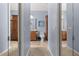 Hallway view of bathroom shows a toilet, vanity with mirror and a tall storage cabinet at 4056 Ashton Club Dr, Lake Wales, FL 33859