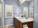 Bright bathroom features dual sinks, granite countertops, and a large window for natural light at 4056 Ashton Club Dr, Lake Wales, FL 33859