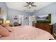 Inviting bedroom features a ceiling fan, large bed, with easy access to bathroom and living area at 4056 Ashton Club Dr, Lake Wales, FL 33859