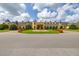Spacious clubhouse exterior featuring a decorative fountain, manicured lawn, and inviting architecture at 4056 Ashton Club Dr, Lake Wales, FL 33859
