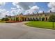 Clubhouse exterior with a tiered fountain, mature landscaping, and porte cochere at 4056 Ashton Club Dr, Lake Wales, FL 33859