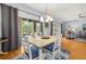 Bright dining room with hardwood floors, modern light fixture and sliding doors to the lanai at 4056 Ashton Club Dr, Lake Wales, FL 33859