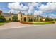 Elegant home showcasing manicured landscaping, a circular driveway, and a charming water fountain feature at 4056 Ashton Club Dr, Lake Wales, FL 33859