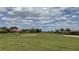 Picturesque golf course view with a sand trap and lush green fairway under a partly cloudy sky at 4056 Ashton Club Dr, Lake Wales, FL 33859