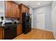 Bright kitchen featuring wood cabinets, black appliances, and a seamless transition with the adjacent rooms at 4056 Ashton Club Dr, Lake Wales, FL 33859