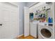 Functional laundry room featuring a washer, dryer, shelving, and closet space for efficient organization at 4056 Ashton Club Dr, Lake Wales, FL 33859