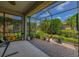 This screened patio features a brick floor and views of lush landscaping at 4056 Ashton Club Dr, Lake Wales, FL 33859