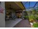 Spacious screened patio with comfortable seating and hammock overlooking the landscaped backyard at 4056 Ashton Club Dr, Lake Wales, FL 33859
