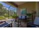 Relaxing screened patio features comfortable seating and lush landscaping for privacy and enjoyment at 4056 Ashton Club Dr, Lake Wales, FL 33859