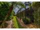 Screened patio exterior with walkway, landscaping, and view of the home's exterior at 4056 Ashton Club Dr, Lake Wales, FL 33859