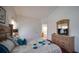 Bedroom featuring a Queen bed, dresser, and an open bathroom at 408 Bloomingdale Dr, Davenport, FL 33897