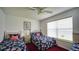 Comfortable bedroom with twin beds, bright window, and ceiling fan offering a welcoming and airy space for relaxation at 408 Bloomingdale Dr, Davenport, FL 33897
