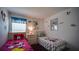 A bedroom featuring twin beds and Disney-themed decor at 408 Bloomingdale Dr, Davenport, FL 33897