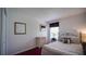 Cozy bedroom featuring red carpet, white walls, a chest of drawers, and an inviting bed near the window at 408 Bloomingdale Dr, Davenport, FL 33897