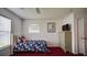 Well-lit bedroom featuring a cozy bed, a TV atop a wardrobe, and a window providing natural light and a view at 408 Bloomingdale Dr, Davenport, FL 33897