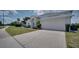 Charming house showing the manicured lawn, lush shrubbery, and a two-car garage at 408 Bloomingdale Dr, Davenport, FL 33897