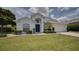 Inviting home exterior showcasing a pristine lawn, charming shrubbery, and an attached garage at 408 Bloomingdale Dr, Davenport, FL 33897