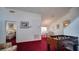 Large room with foosball table, visible dining area, and access to a cozy bedroom at 408 Bloomingdale Dr, Davenport, FL 33897