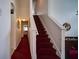Bright hallway features carpeted stairs, leading to additional rooms and an entertainment space at 408 Bloomingdale Dr, Davenport, FL 33897