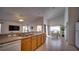 Open kitchen layout with countertops, double sink, wood cabinets, and eat-in dining area at 408 Bloomingdale Dr, Davenport, FL 33897