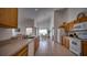 Long view of kitchen featuring countertops, double sink, wood cabinets, and eat-in dining area at 408 Bloomingdale Dr, Davenport, FL 33897