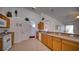 View of the kitchen showcasing countertops, sink, and white appliances against white walls at 408 Bloomingdale Dr, Davenport, FL 33897