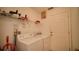 The laundry room features a washer, dryer, storage shelf, and a white door at 408 Bloomingdale Dr, Davenport, FL 33897