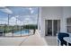 This screened pool with lake view provides ample lounging space around a clean blue pool at 408 Bloomingdale Dr, Davenport, FL 33897