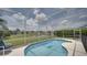 Sparkling pool within a screened enclosure, offering serene water views and comfortable poolside seating at 408 Bloomingdale Dr, Davenport, FL 33897