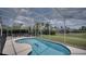 Beautiful in-ground pool surrounded by a screen enclosure and overlooking a well-maintained backyard at 408 Bloomingdale Dr, Davenport, FL 33897