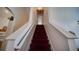 Carpeted staircase with white railings leading upstairs, creating a grand entrance and a pathway to the upper level at 408 Bloomingdale Dr, Davenport, FL 33897
